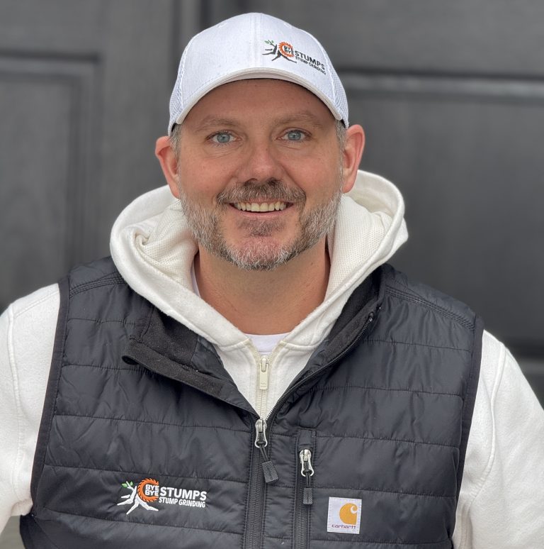 Chris, owner of Bye Bye Stumps, wearing his company’s logo on his cap and vest